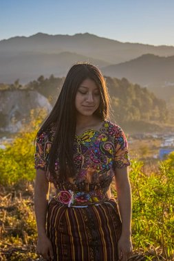 Kadın, tipik güzel renk kostümüyle oturuyor.