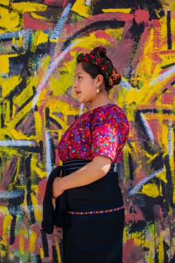 Arka planda duvarları olan yerli bir kadın, Chiquirichapa.