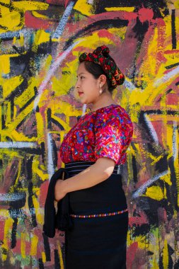 Arkaplan duvarı olan kadın Chiquirichapa 'daki noktalardan oluşan pinatada