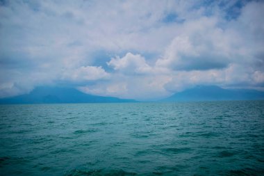 Beyaz bulutlar ve dağlarla AtitIn Gölü