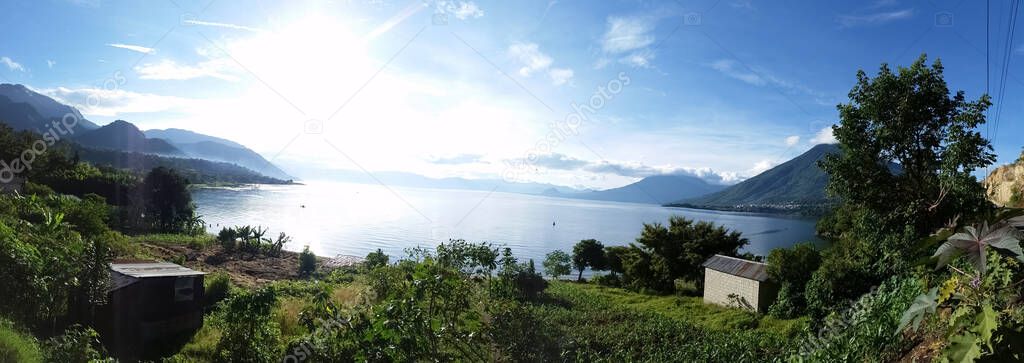 panoramic sunrise lake landscape with green trees