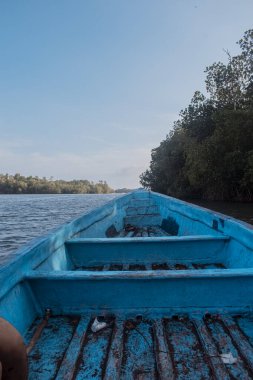 Beautiful summer sunset bluish sky, flared clouds waves boats, palm trees, sea and sand