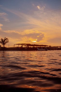 sunset on the river with galley silhouette with red sky