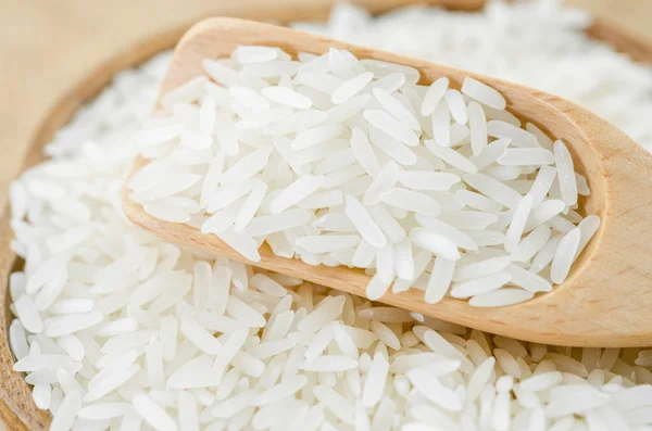 Jasmine rice with wooden spoon — Stock Photo, Image