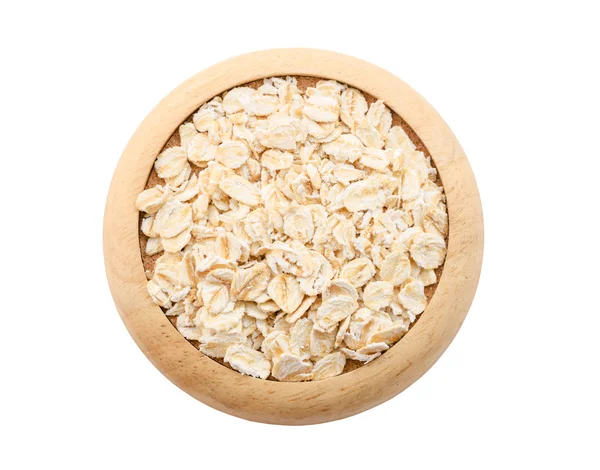 Oat flakes pile in wooden dish. — Stock Photo, Image