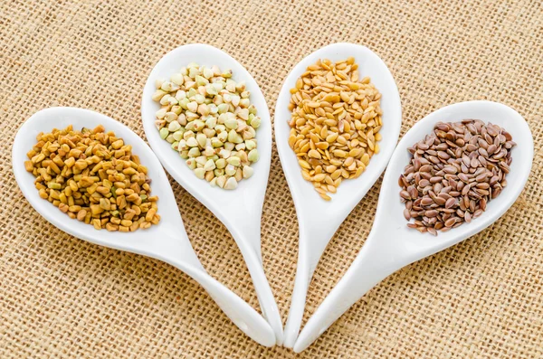 Zaden van fenegriek, bukwheat zaden, gouden lijnzaad en bruin linsee — Stockfoto