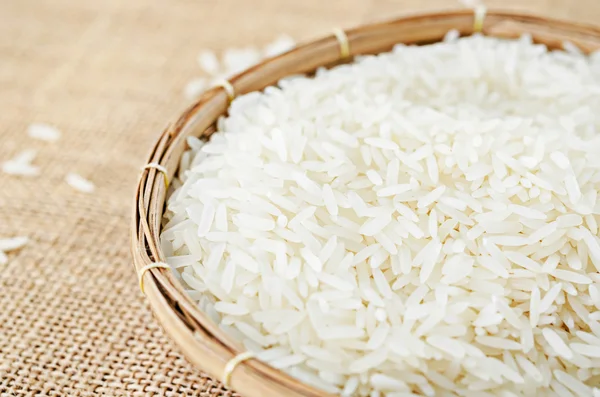 Raw white rice in wood weave basket. — Stock Photo, Image