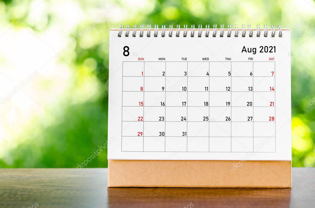 August 2021 Calendar desk for organizer to plan and reminder on wooden table on nature background.