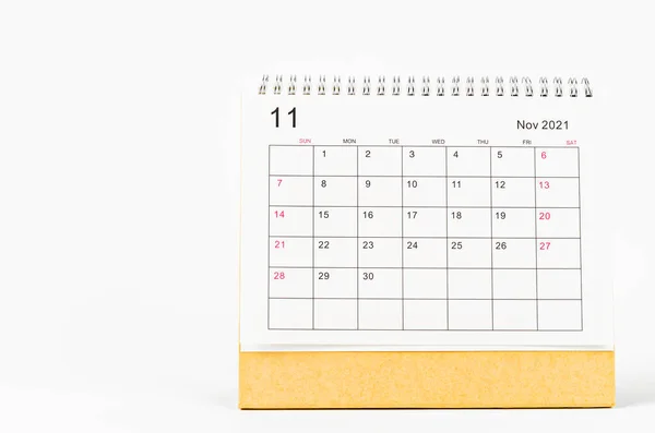 November 2021 Calendar desk for organizer to plan and reminder on wooden table.