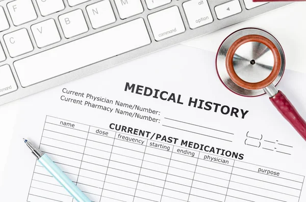 Medical history form document and stethoscope medical with keyboard computer.