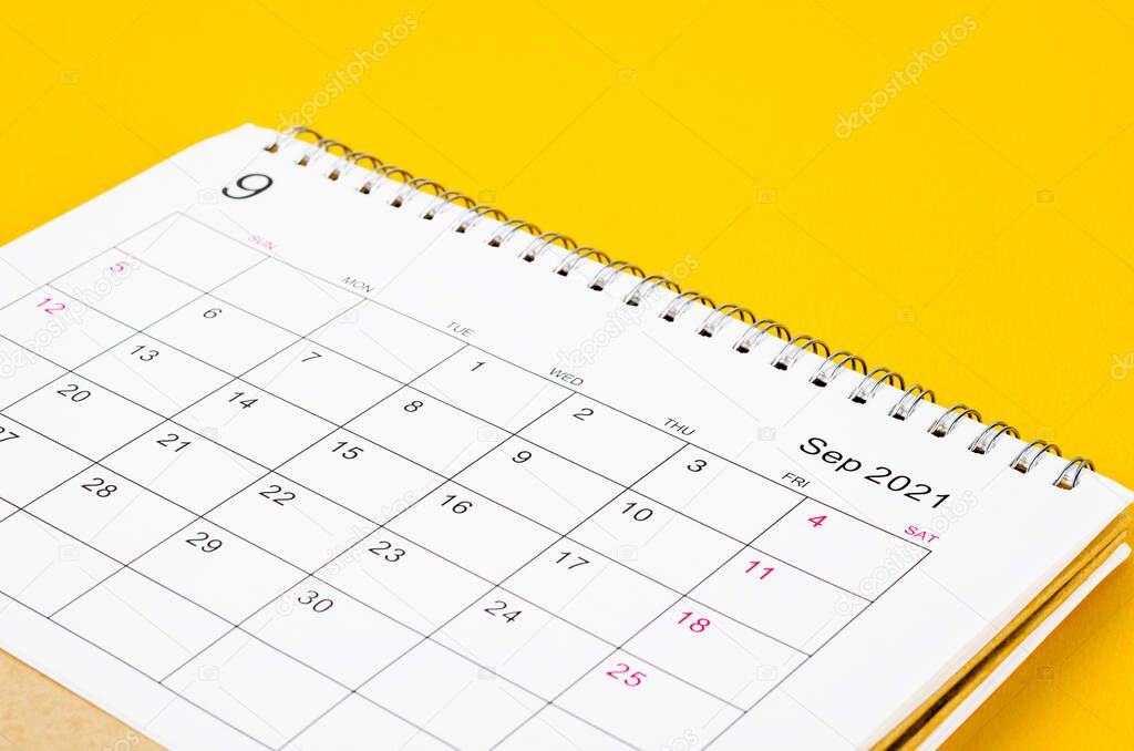 Close up September 2021 Calendar desk for organizer to plan and reminder on yellow background.