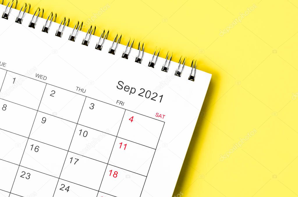 Close up September 2021 Calendar desk for organizer to plan and reminder on yellow background.