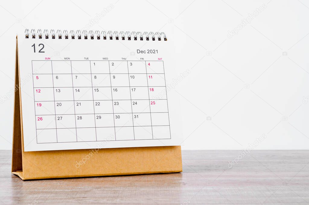 December Calendar 2021 on wooden table background.