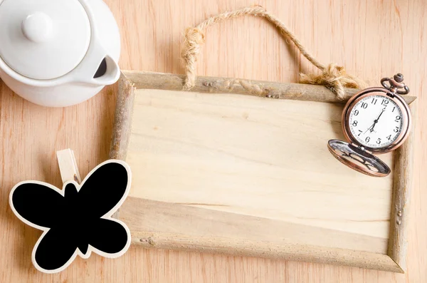 Wooden photo frame, vintage pocket watch, and blank black tag. — ストック写真