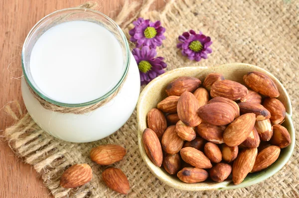 Glass of almond milk with almonds. — Stock Photo, Image