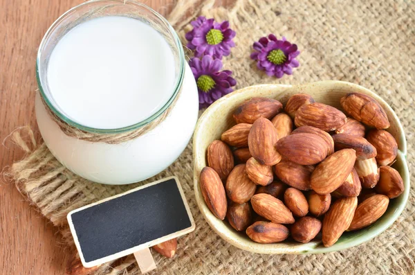 Almond milk in glass with almonds — Stock Photo, Image
