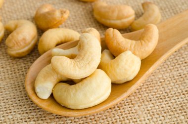 Cashews close-up in wooden spoon. clipart