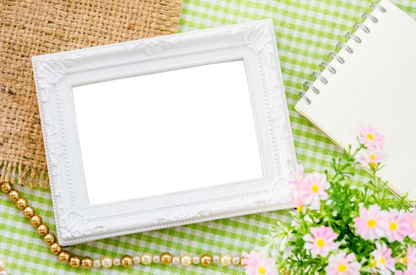 Blank vintage white photo frame and open diary — Stock Photo, Image