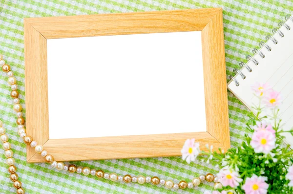 Blank vintage wooden photo frame and open diary. — Stock Photo, Image