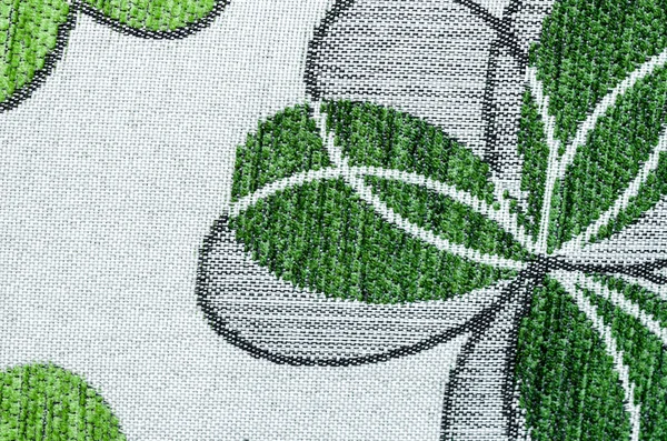 Embroidery of green leaf on linen beige fabric. — Stock Photo, Image