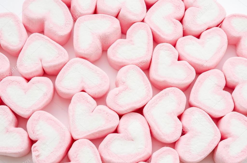 Pink fluffy heart shaped marshmallows candy background. Stock Photo by  ©galiyahassan 340052556