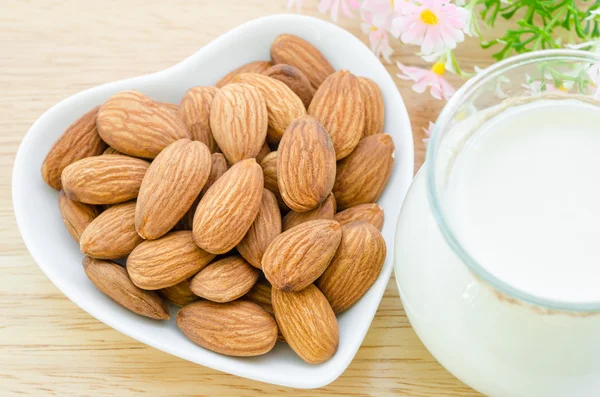 Almond milk with almond on a white bowl cup. — Stock Photo, Image