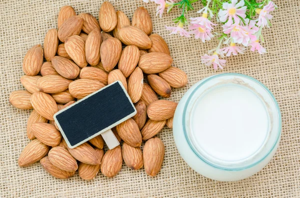 Almonds and almond milk in glass. — Stock Photo, Image