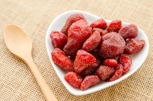 Dried strawberries in white bowl heart shap. — Stock Photo, Image