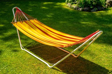 Yazın bahçede metal bir büfede kumaş hamak.