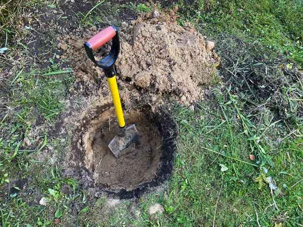 Gul Metallspade Ett Runt Hål Grävt Marken Bredvid Ett Berg — Stockfoto