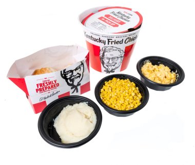 Winneconne, WI - 20 June 2021:  A package of KFC Kentucky Fried Chicken bucket with mashed potatoes, whole kernal corn and mac and cheese colonel sanders on an isolated background clipart