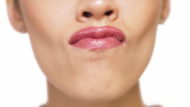 Close-up of a girl cleaning her teeth from lipstick with her tongue — Stock Video