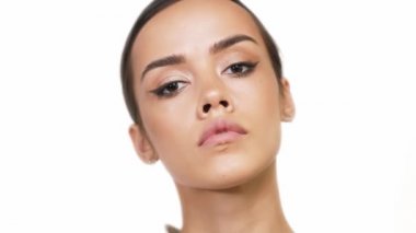 Kahverengi gözlü tatlı esmer beyaz arka planda harika makyaj gösteriyor.