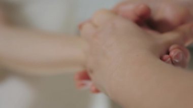 Güzel esmer kadın güzellik salonunun parlak ofisinde el masajı yaptırıyor.