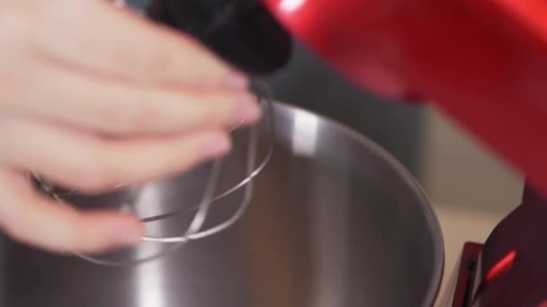 Close-up of installing a clean whisk in a red planetary mixer. — Video Stock