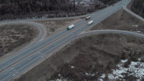 A car interchange with an overpass on a cloudy spring evening in the woods — Stock Video