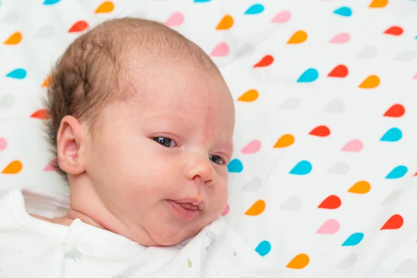 Porträt eines neugeborenen Babys, das in die Kamera blickt — Stockfoto