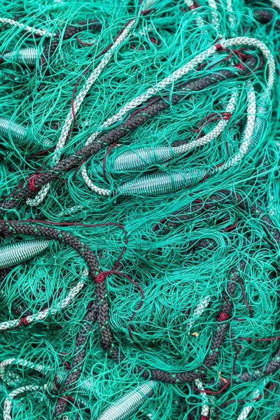 Green fishing net on the heap, closeup view — Stock Photo, Image