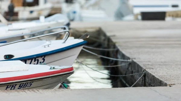 Fishermen's boats parked and tied in city harbour in Veli Iz