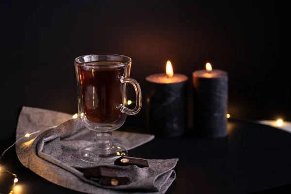 Glass Cup Tea Black Background Two Black Candles Chocolate — Stock Photo, Image
