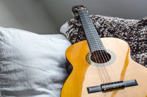 Acoustic Guitar on the white sofa — Stock Photo, Image