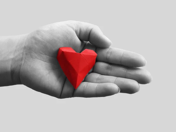 Origami heart in hand — Stock Photo, Image
