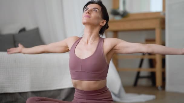 Caucasian woman in sportswear performs yoga relax asanas pranayama — Stock Video