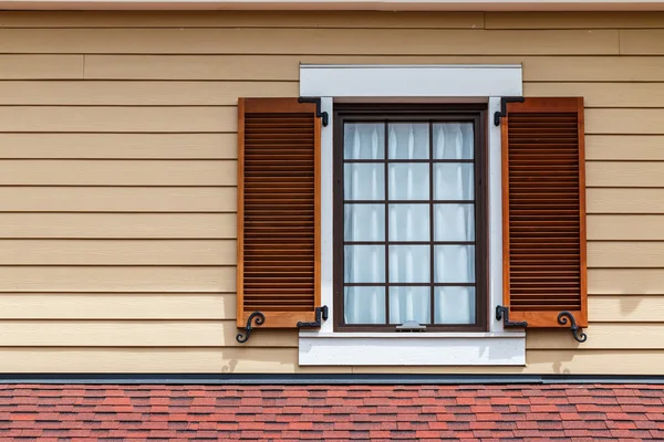 Window with brown shutters Royalty Free Stock Images