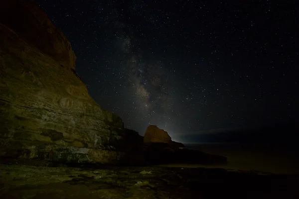 Rochers côtiers avec étoiles et voie lactée — Photo