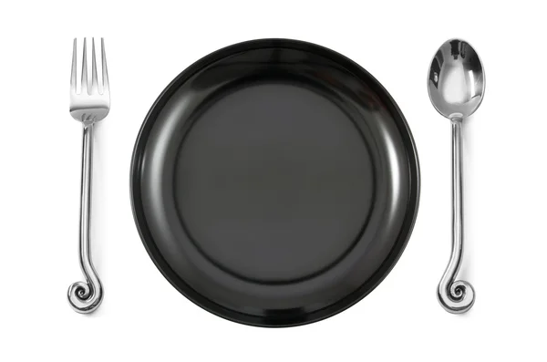 Dinner place setting a white plate with silver fork and spoon — Stock Photo, Image