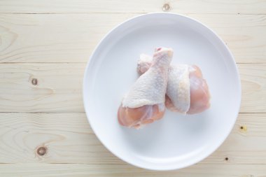 Ahşap üzerinde bir plaka ile taze tavuk sopaları.