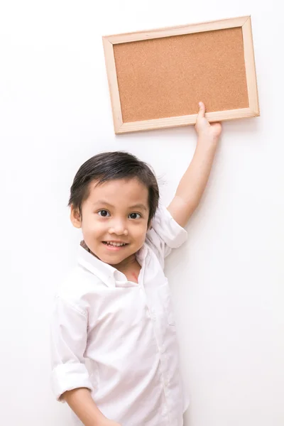 Portrait of a little boy holding a board — Stock Photo, Image