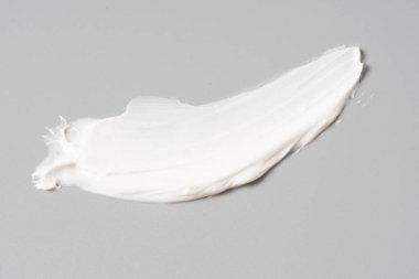 Beyaz arkaplanda beyaz kozmetik yüz kremi dokusu