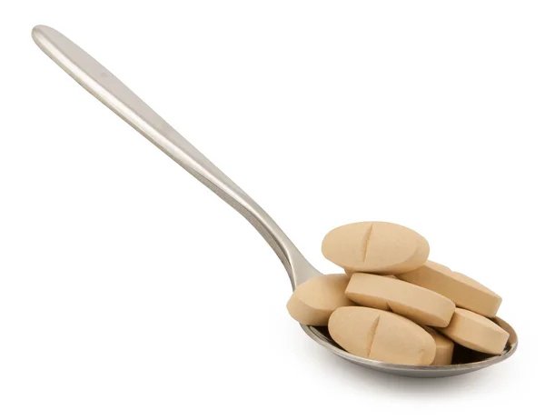 Vitamin-pills on spoon — Stock Photo, Image